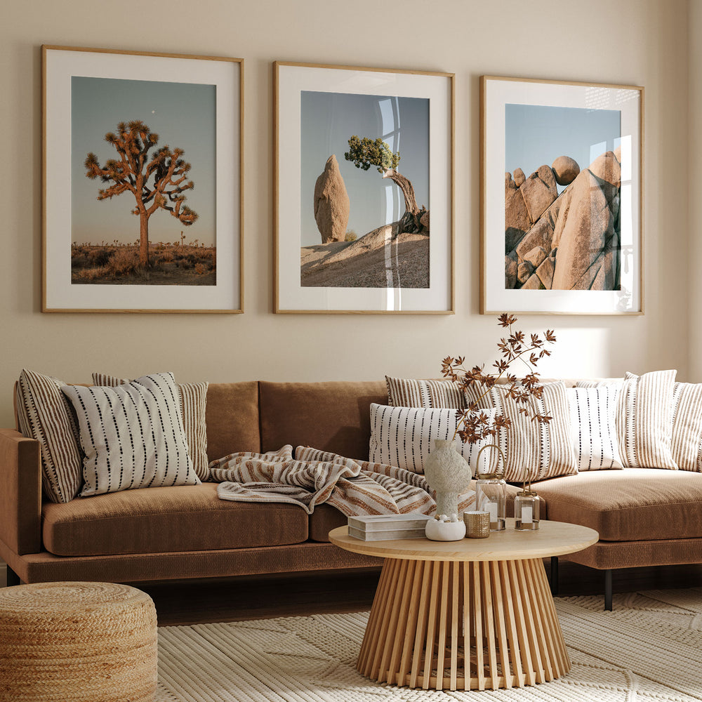 a living room filled with furniture and pictures on the wall