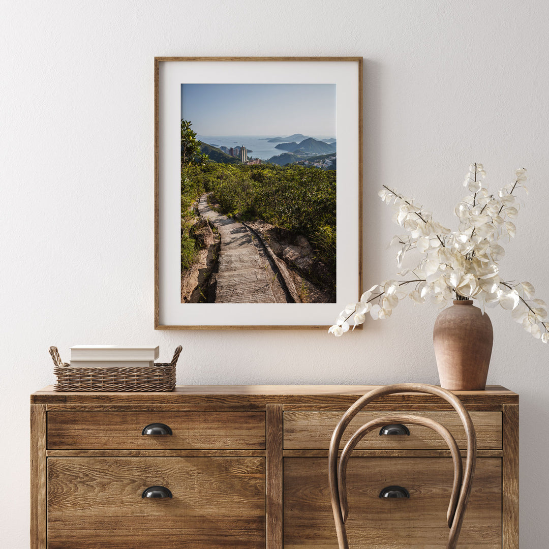 a wooden dresser with a picture hanging on the wall