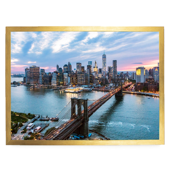 a cityscape with a bridge spanning a river, surrounded by tall buildings and skyscrapers. The sky is filled with clouds, creating a dramatic backdrop for the city's skyline.