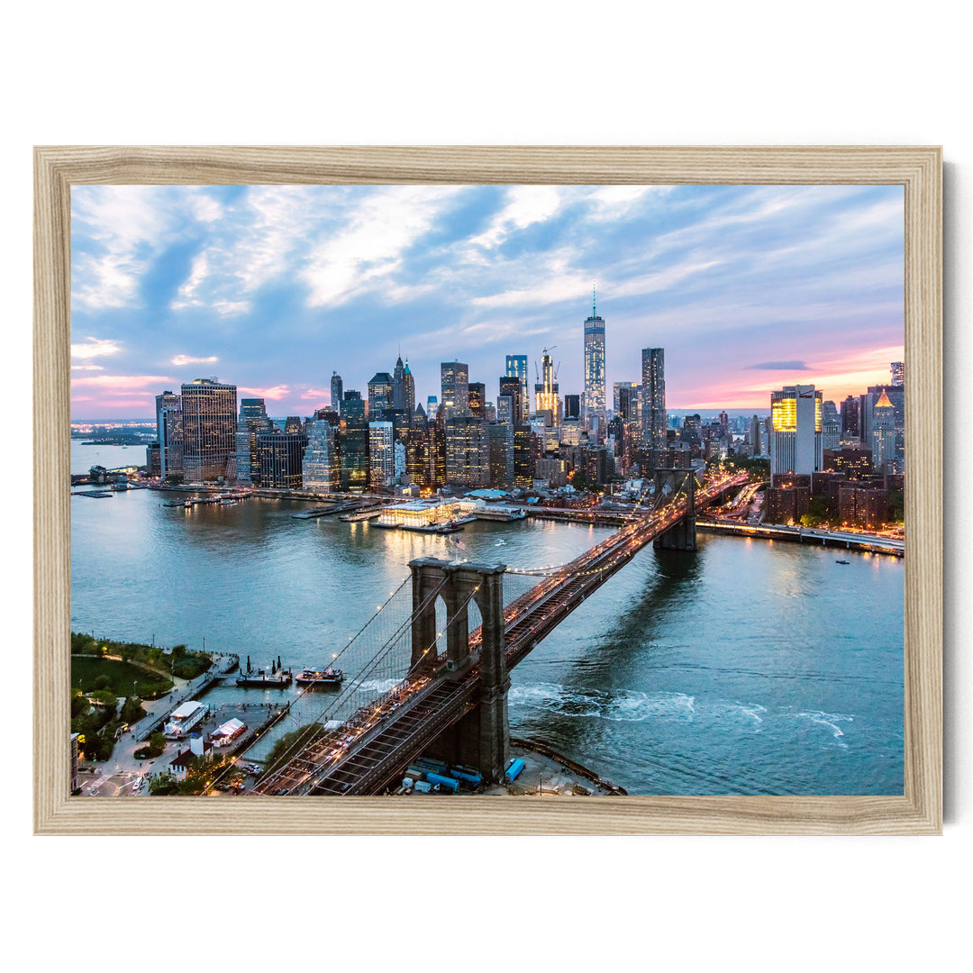 a cityscape with a bridge spanning a large body of water, surrounded by tall buildings and skyscrapers. The sky is filled with clouds, creating a dramatic backdrop for the city's skyline.