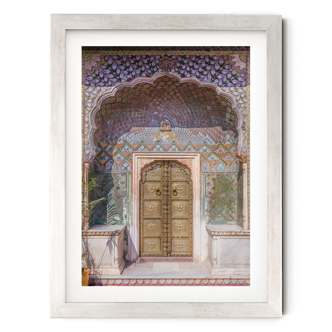 a large, ornate golden door with intricate designs and patterns, set within a colorful, decorative archway.