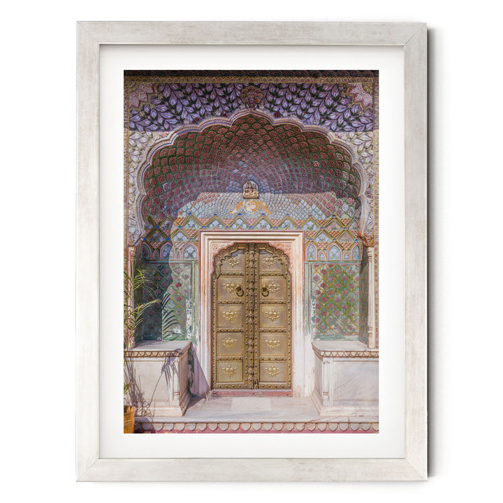 a large, ornate golden door with intricate designs and patterns, set within a colorful, decorative archway.