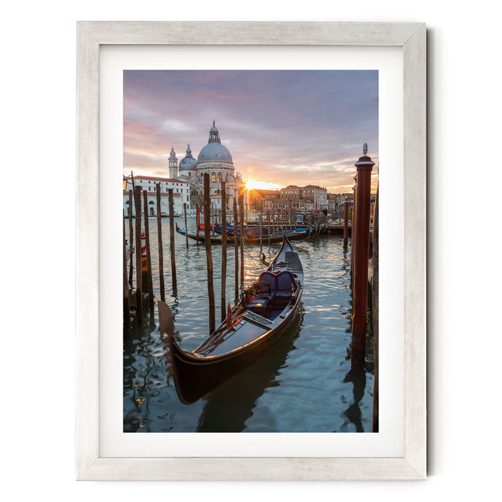 a serene scene of a gondola floating on the water, with a picturesque view of the iconic domes and buildings of Venice, Italy, in the background.