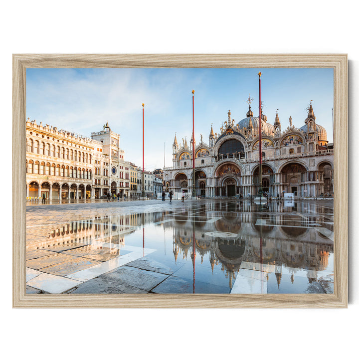 a large, ornate building with multiple domes and arches, reflecting in a large pool of water in the foreground. The building is surrounded by other buildings, creating a picturesque scene.