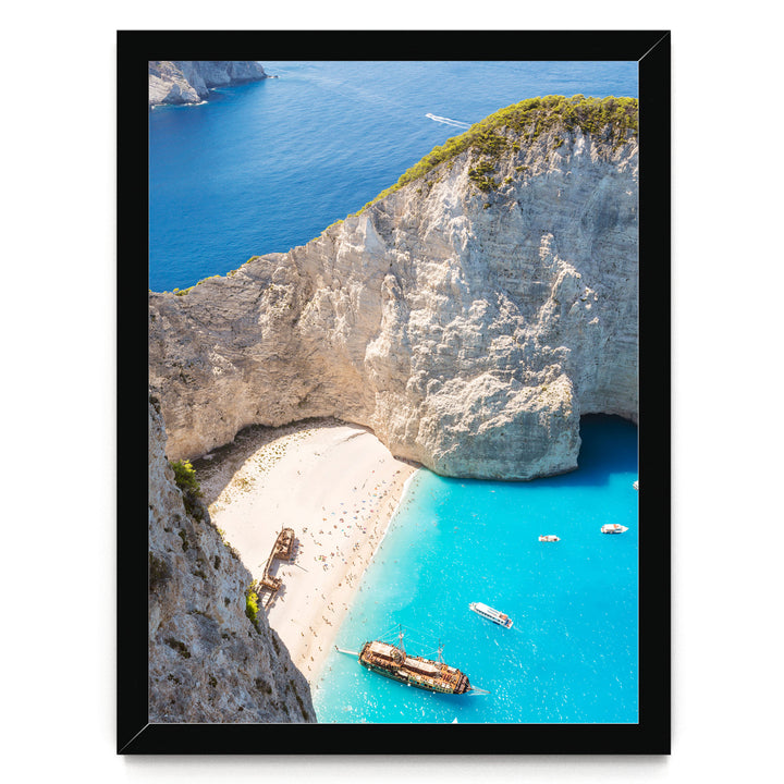 a picturesque coastal scene with a rocky cliff overlooking a beach and turquoise waters. Several boats are visible in the water, adding to the serene atmosphere.