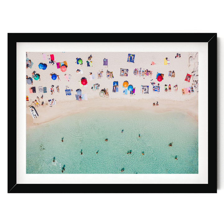 a crowded beach with numerous people enjoying the sun, sand, and water.