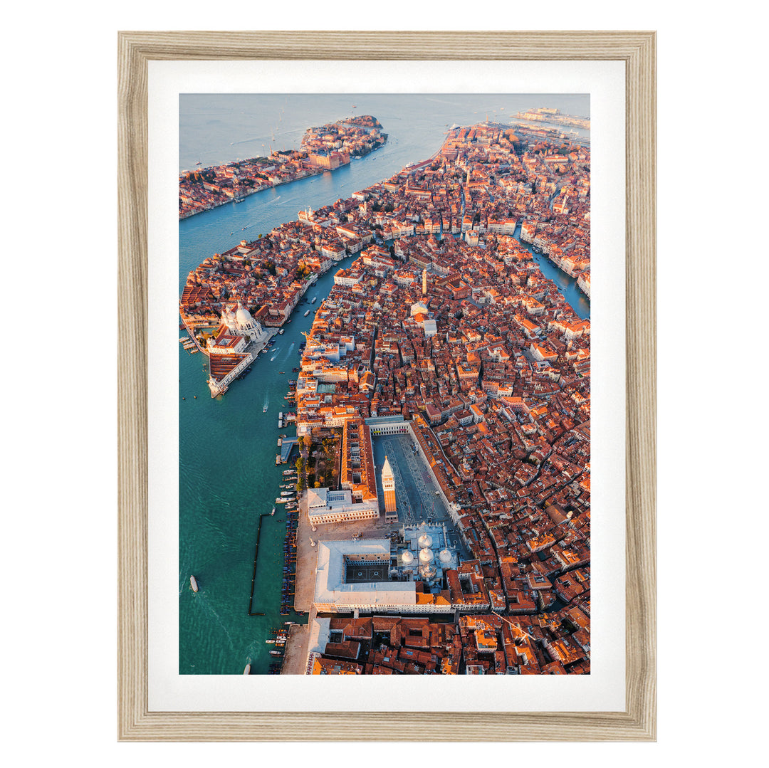 An aerial view of the city of Venice, Italy, showcasing its iconic canals, domes, and buildings.