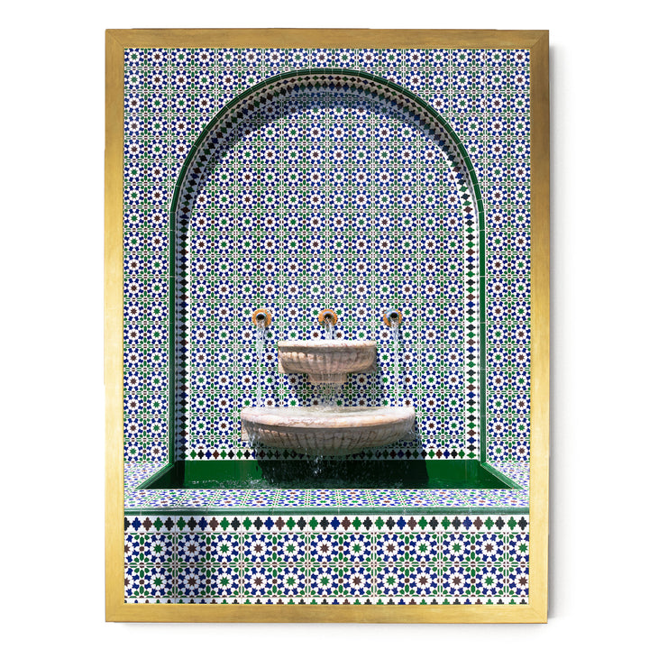 a decorative fountain with a tiled wall backdrop.