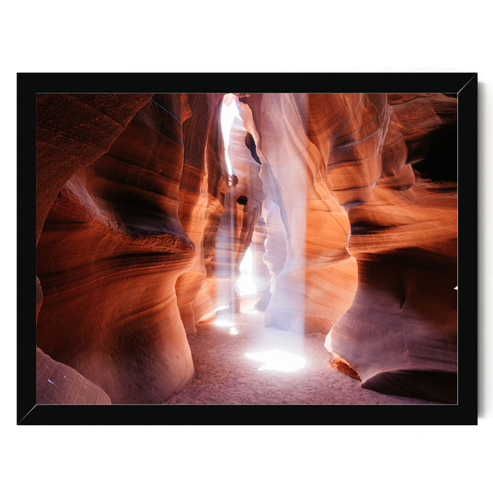 A framed photograph depicting a narrow, winding path illuminated by a bright light source, creating a dramatic and visually striking scene.