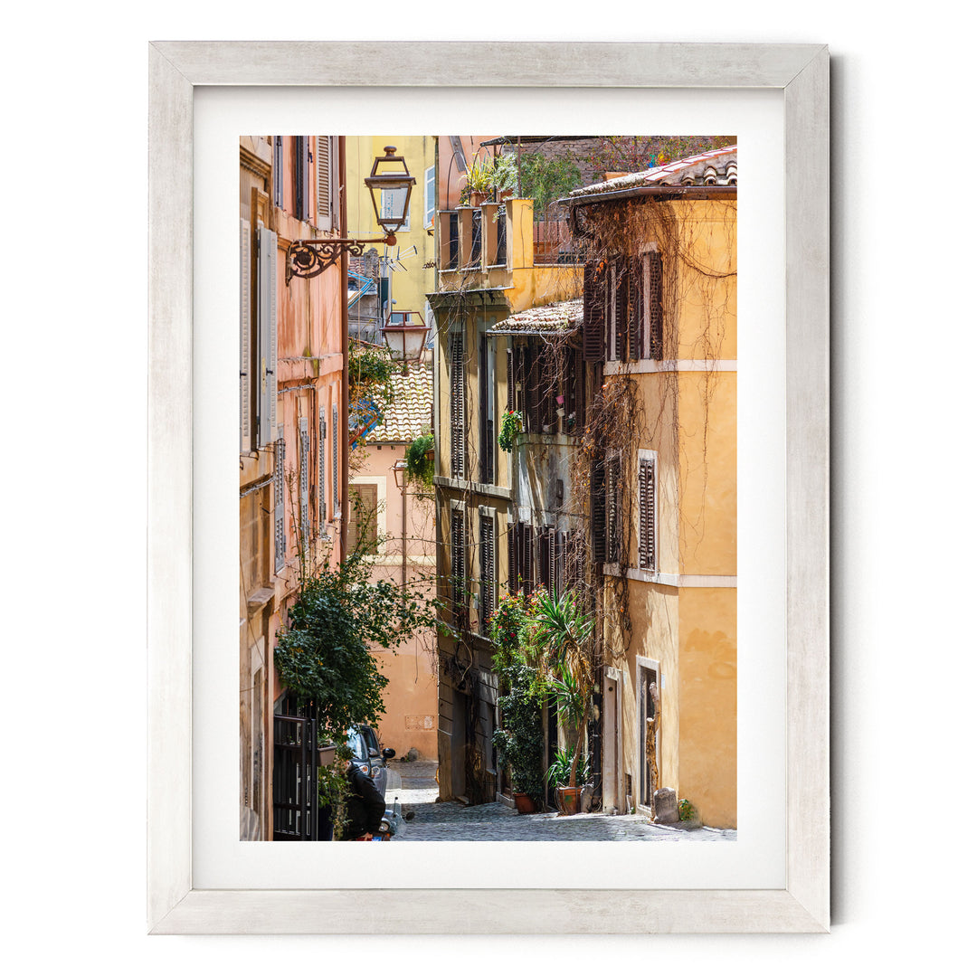 a narrow, cobblestone street lined with colorful buildings and lush greenery, creating a picturesque and charming scene.
