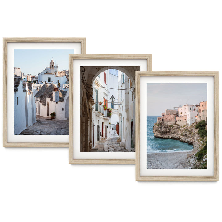 The image is a collage of three framed pictures, each depicting different scenes of coastal towns and villages. The first picture shows a narrow street lined with white buildings, the second picture depicts a picturesque alleyway with a lighthouse, and the third picture captures a beach with a rocky cliff overlooking the ocean.