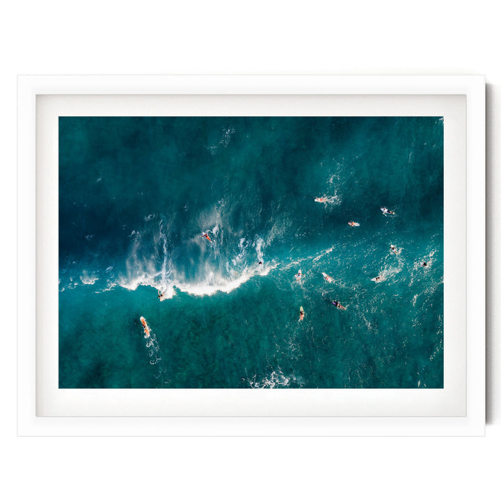 a group of people surfing in the ocean, with waves crashing around them.