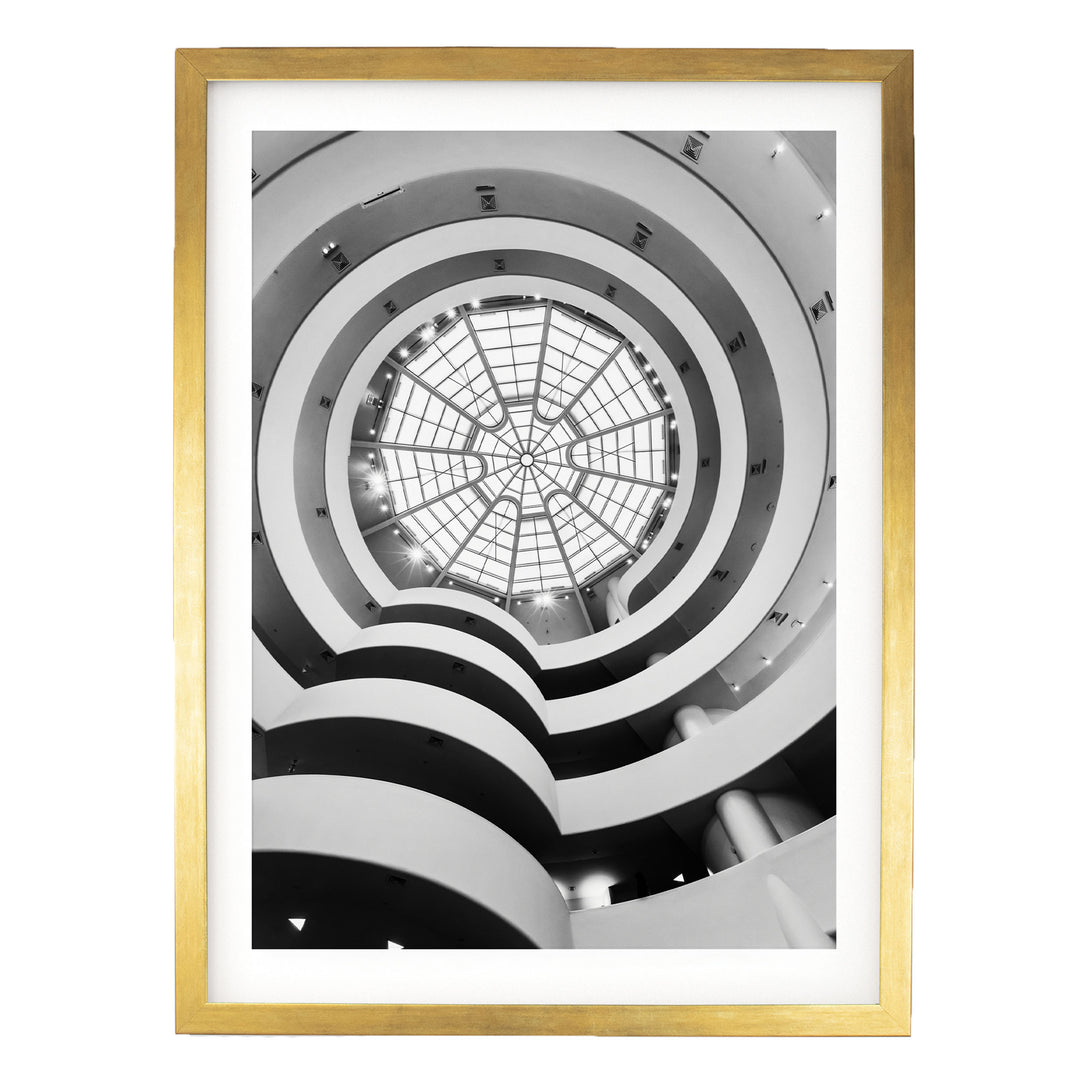 The image is a black and white photograph of a modern architectural structure with a circular glass dome at the center, surrounded by multiple levels of curved walls.