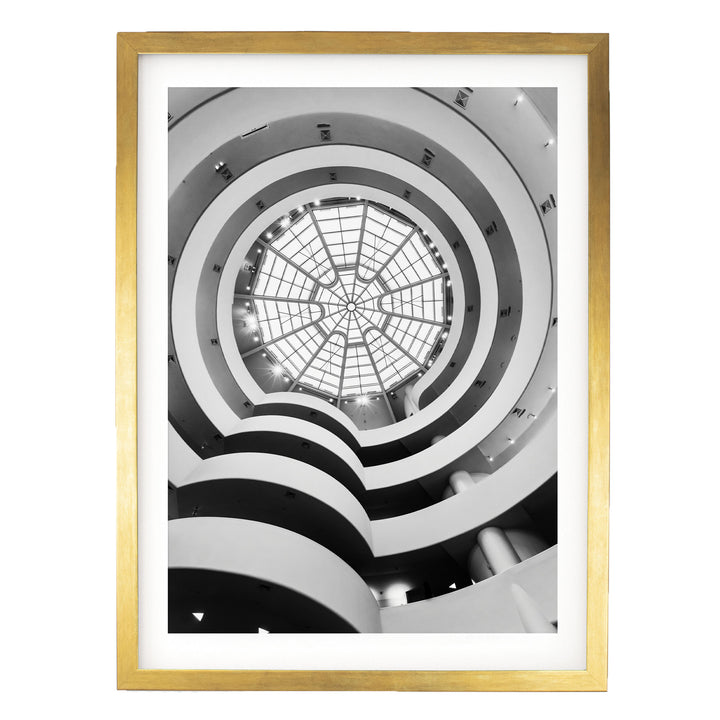 The image is a black and white photograph of a modern architectural structure with a circular glass dome at the center, surrounded by multiple levels of curved walls.