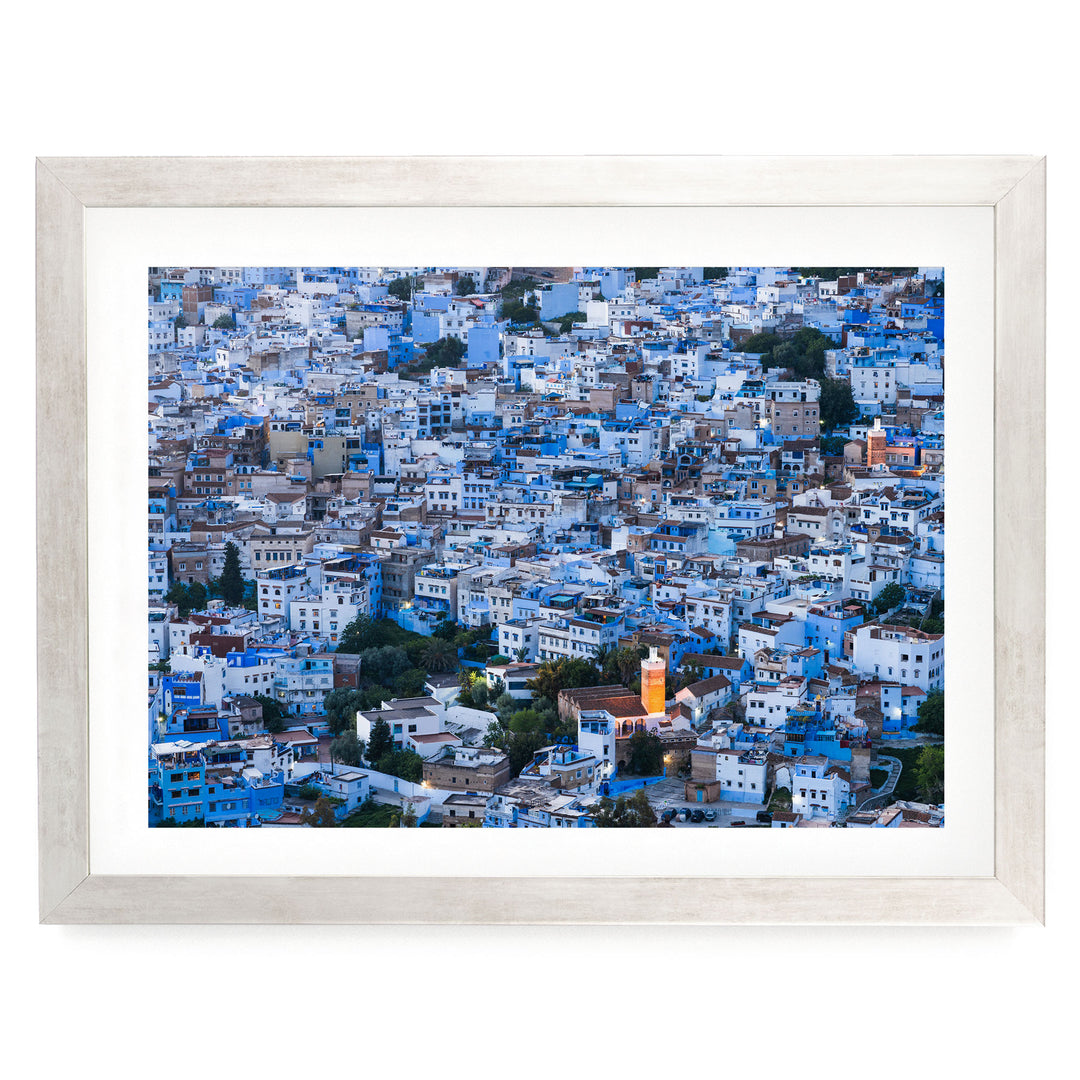 a densely packed cityscape with numerous buildings in shades of blue and white, creating a visually striking and vibrant urban landscape.