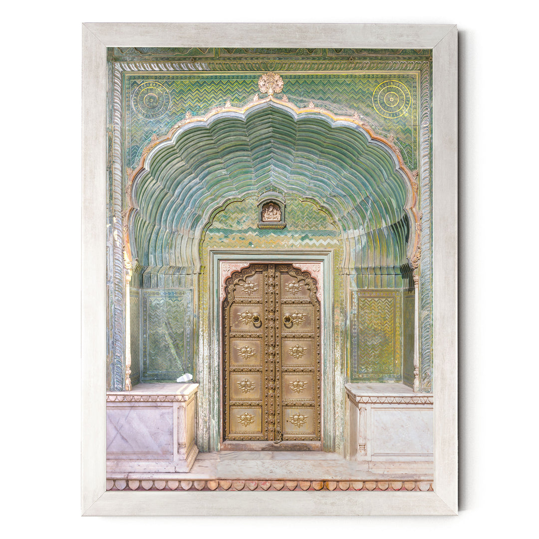 a large, ornate golden door with intricate carvings and patterns, set within an elaborate archway.