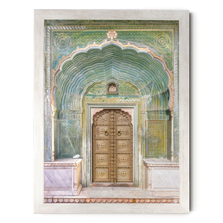 a large, ornate golden door with intricate carvings and patterns, set within an elaborate archway.