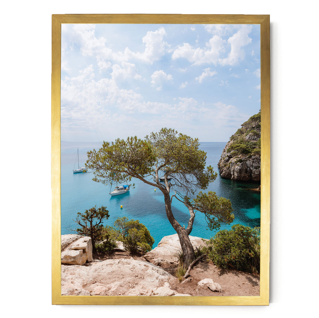 a serene coastal landscape with a rocky cliff overlooking a turquoise sea dotted with boats.