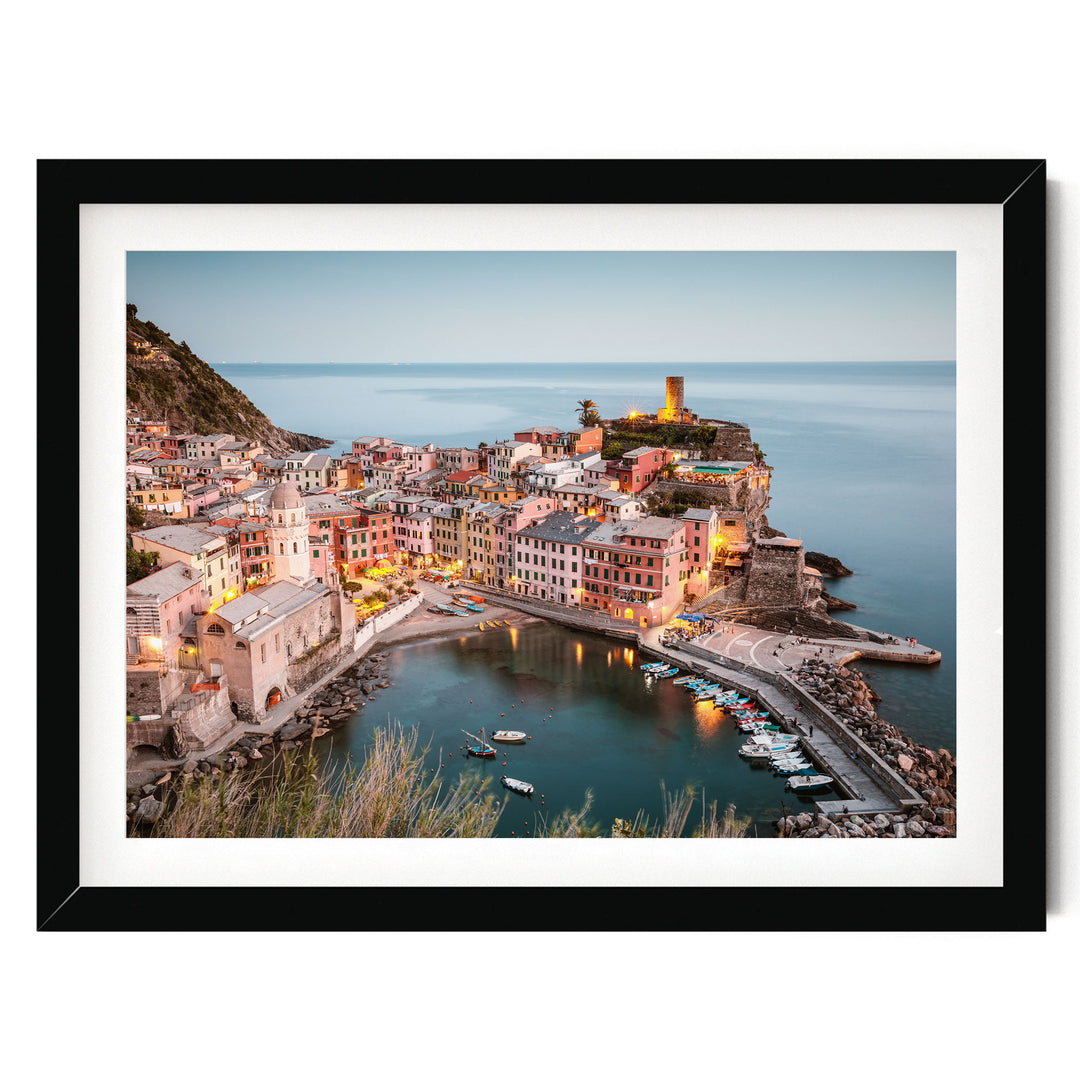 a picturesque coastal town with colorful buildings, a harbor filled with boats, and a lighthouse on a cliff overlooking the water.