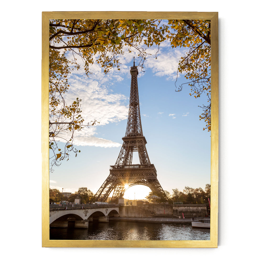 the Eiffel Tower, a famous landmark in Paris, France, with a bridge and trees in the foreground.
