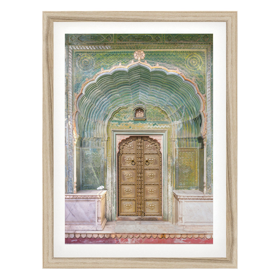 a large, ornate wooden door with intricate carvings and patterns, set within an elaborate archway.