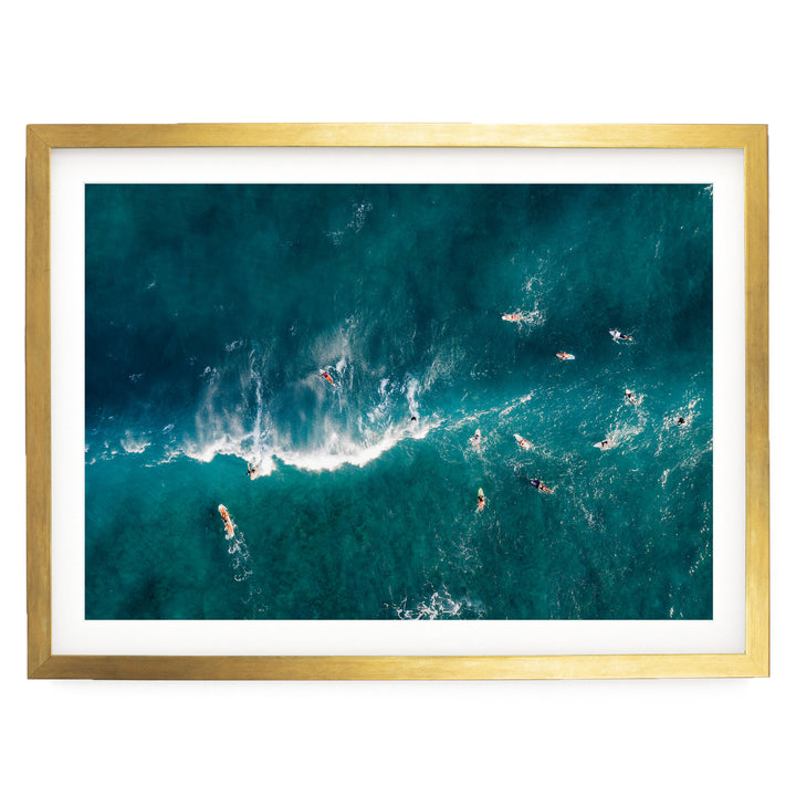 a group of people surfing on a large, turquoise ocean wave.