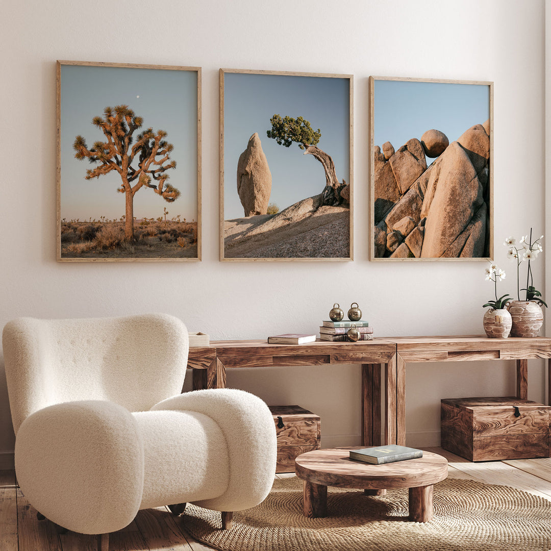 a living room with three pictures on the wall