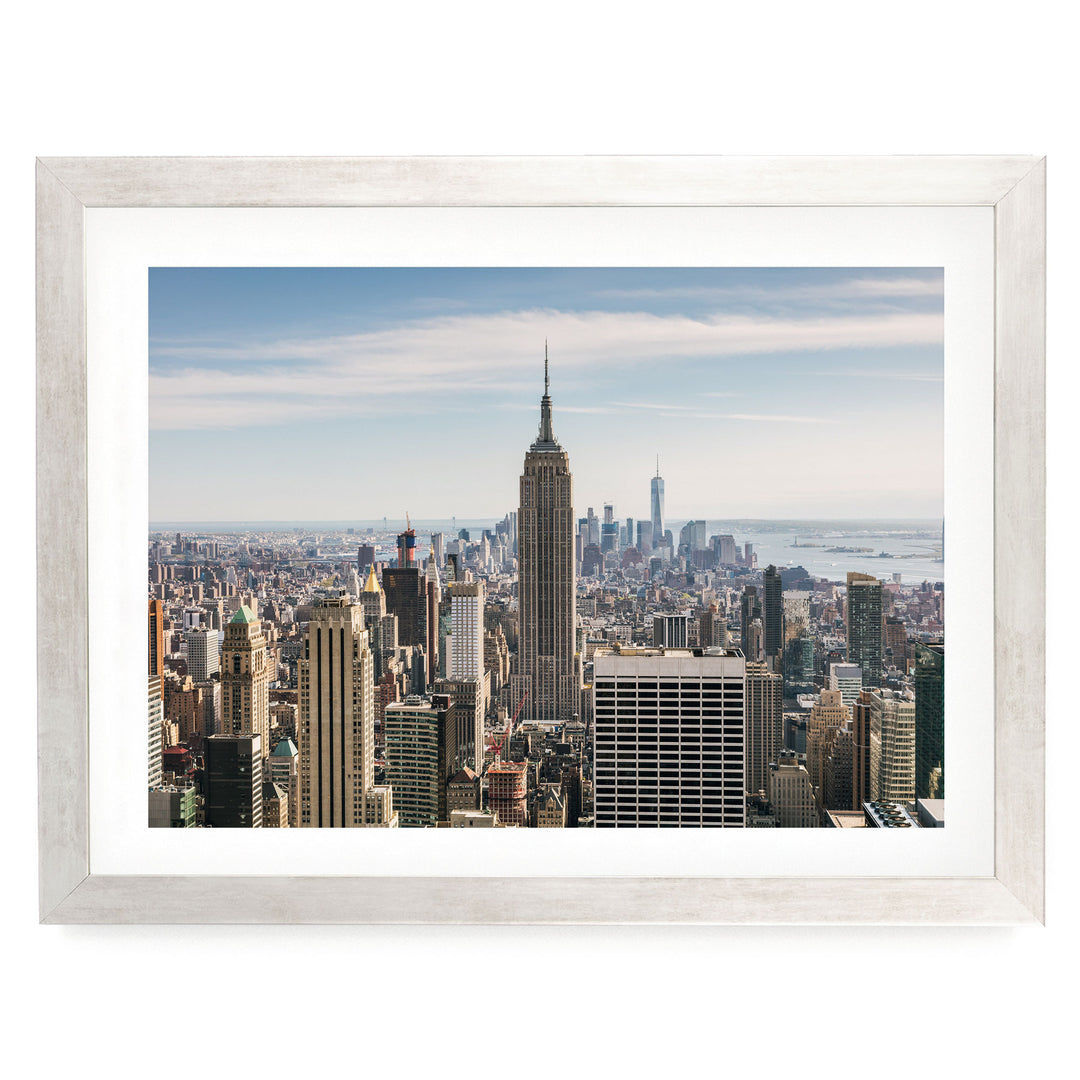 a panoramic view of the New York City skyline, with the iconic Empire State Building prominently featured in the center of the frame.