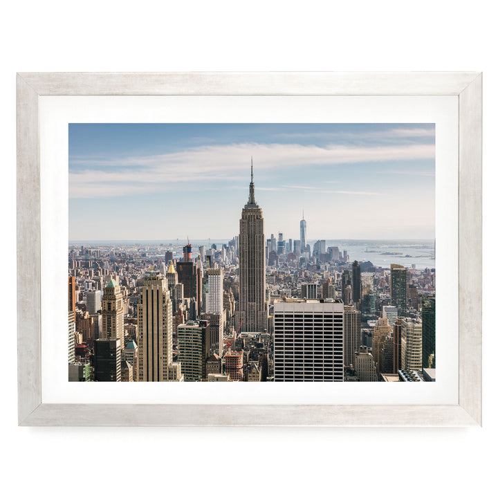a panoramic view of the New York City skyline, with the iconic Empire State Building prominently featured in the center of the frame.