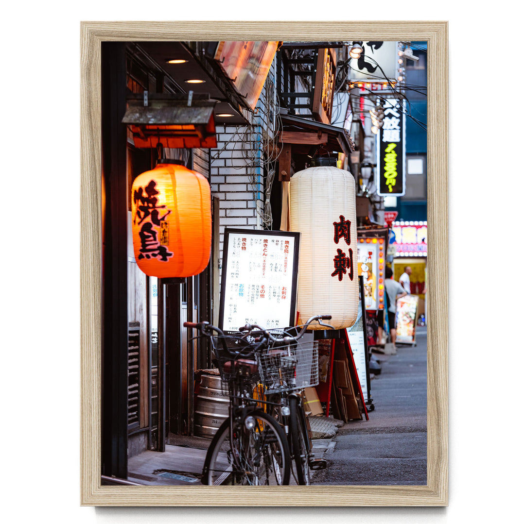 a vibrant street scene in Japan, with colorful lanterns hanging from the buildings and a bicycle parked on the sidewalk.