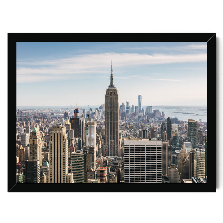 a panoramic view of the New York City skyline, featuring the iconic Empire State Building and other skyscrapers.