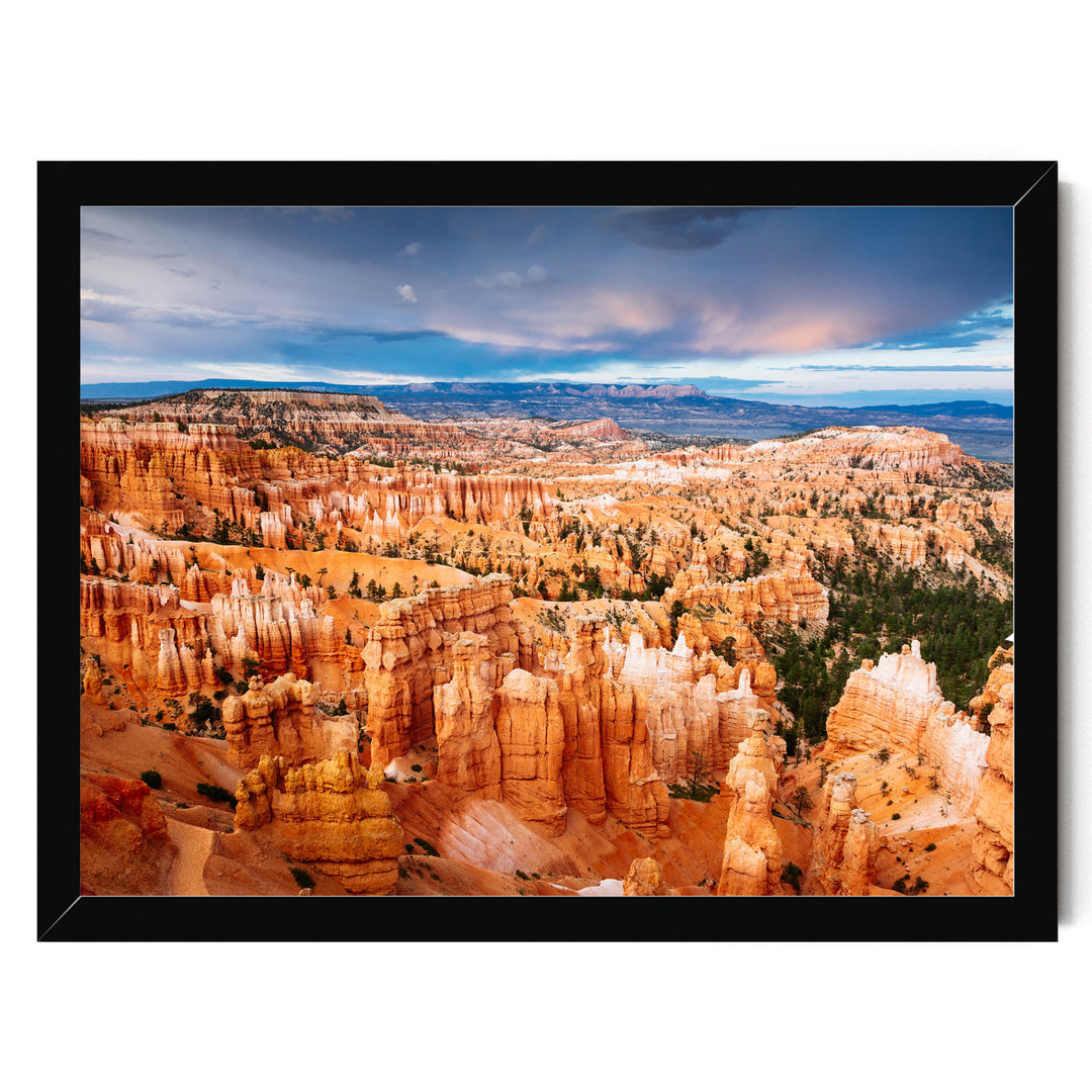 a breathtaking view of a canyon with towering red rock formations, set against a dramatic cloudy sky.