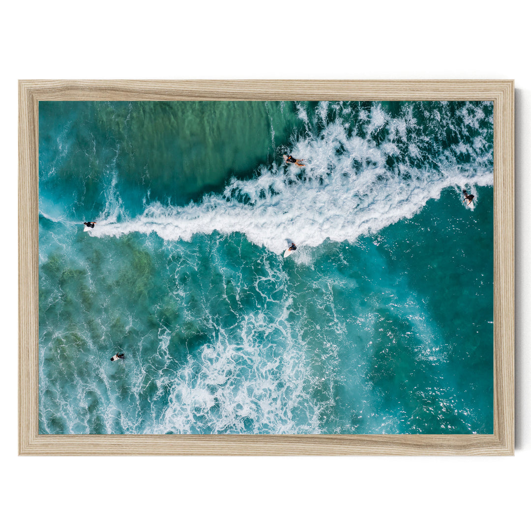a group of people surfing on a large, foamy wave in the ocean.
