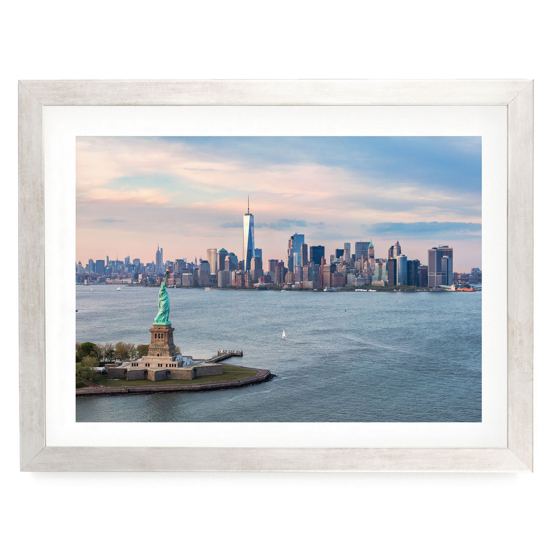 a framed view of the Statue of Liberty in New York City, with the city skyline in the background.