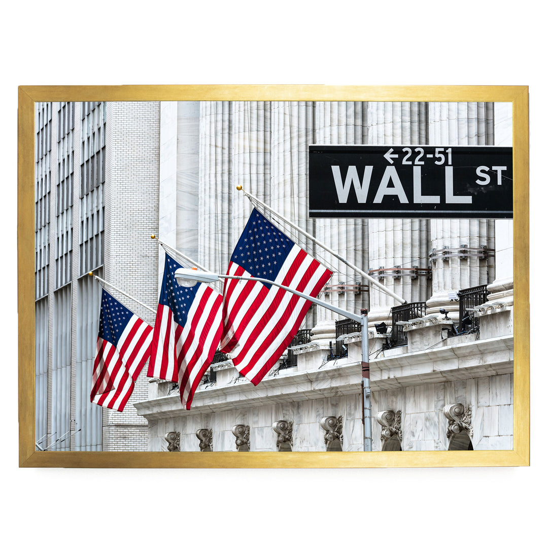 a large building with American flags flying in front of it, and a street sign reading "22-51 WALL ST" is visible in the background.