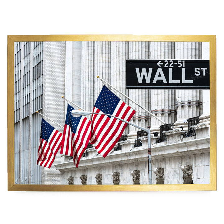 a large building with American flags flying in front of it, and a street sign reading "22-51 WALL ST" is visible in the background.