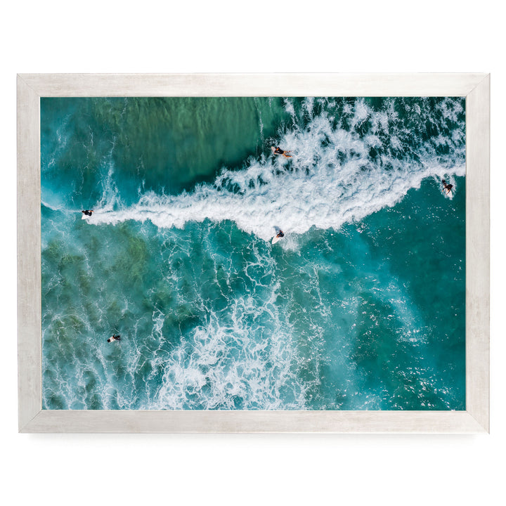 a group of people surfing on a large, foamy wave in the ocean.