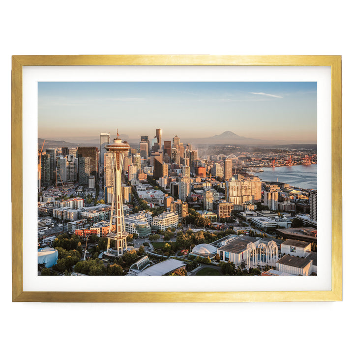 The image is a panoramic view of the Seattle skyline, showcasing the iconic Space Needle and the surrounding cityscape.