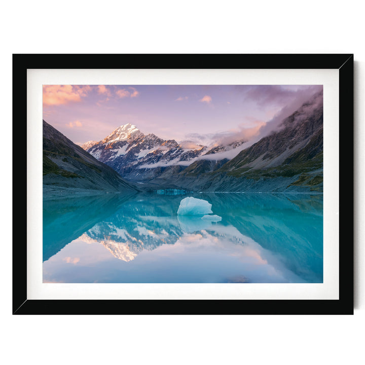 A breathtaking landscape featuring a serene lake surrounded by majestic snow-capped mountains, with the mountains' peaks reflected perfectly in the tranquil waters.