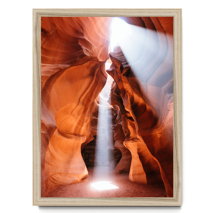 a stunning natural rock formation with a bright light shining through the narrow passage, creating a dramatic and captivating scene.