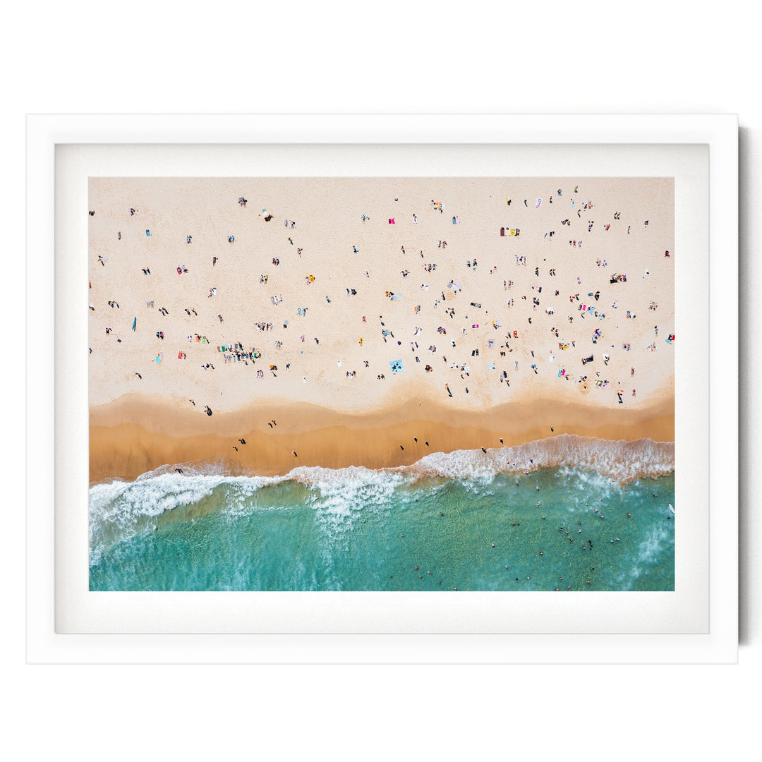 a crowded beach with many people enjoying the sun, sand, and water.