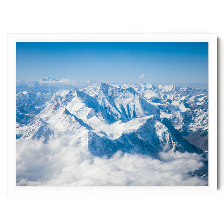 a breathtaking view of snow-capped mountains rising majestically from a vast expanse of clouds, creating a stunning and awe-inspiring landscape.