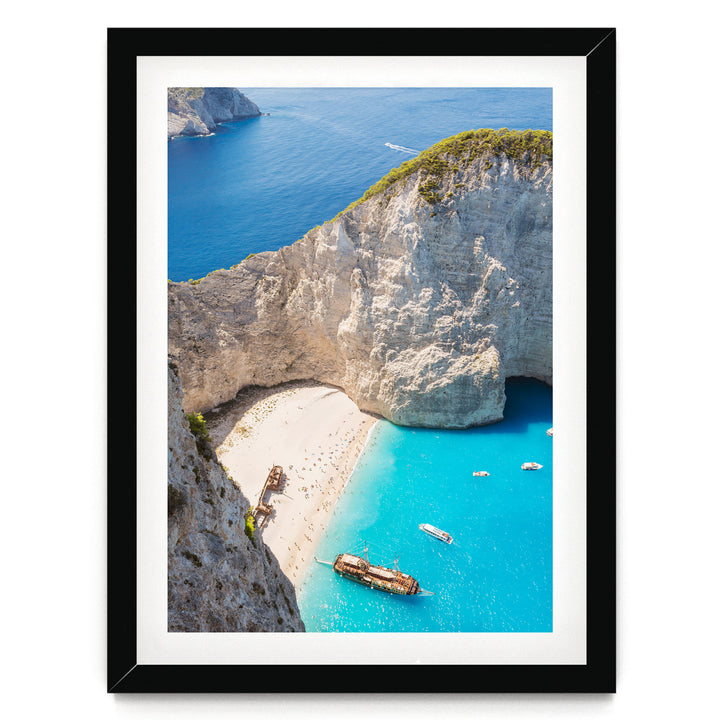 a picturesque coastal scene with a rocky cliff overlooking a turquoise sea dotted with boats.