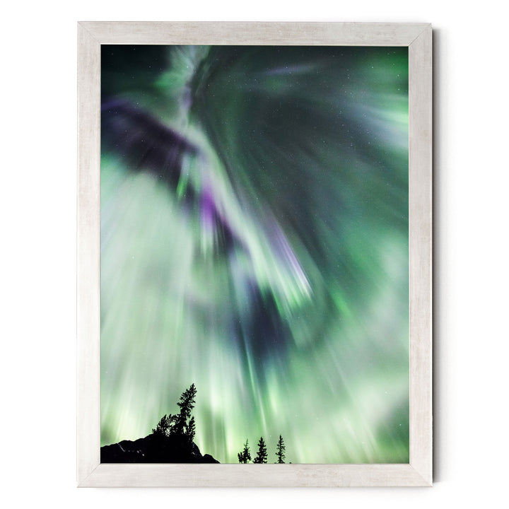 a stunning display of the Aurora Borealis, or Northern Lights, with vibrant green and purple hues swirling across the night sky.