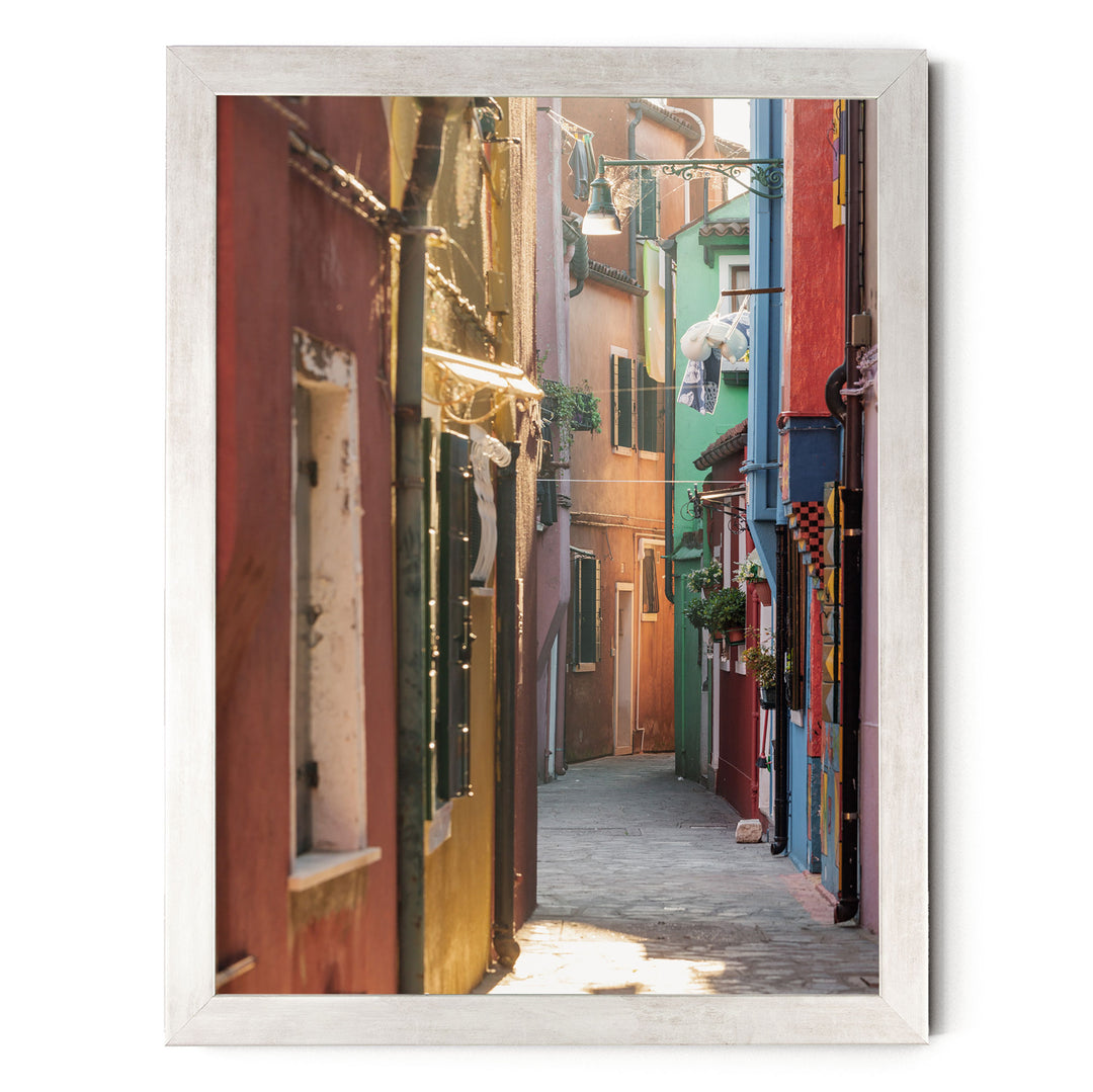 a narrow, colorful alleyway in a city, with buildings painted in various vibrant colors lining the sides.