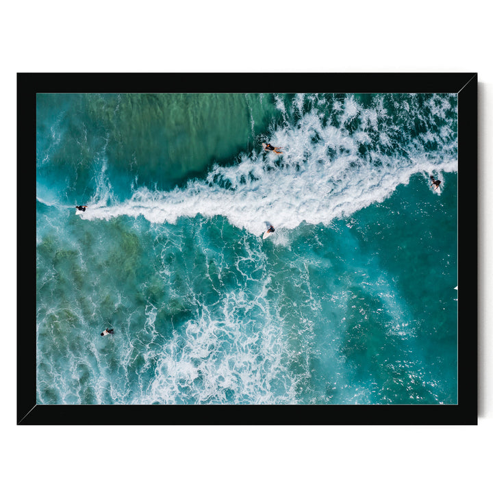 a group of people surfing on a large, foamy wave in the ocean.