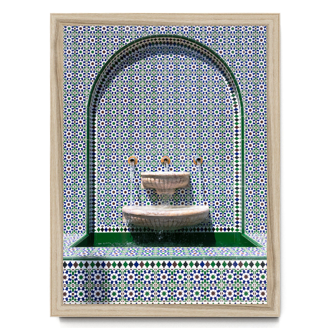 a decorative fountain with a tiled wall backdrop.