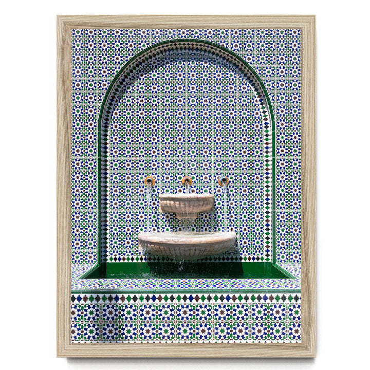 a decorative fountain with a tiled wall backdrop.