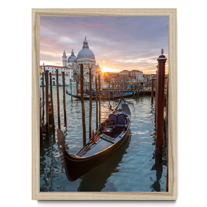 a serene scene of a gondola floating on the water, with a picturesque view of the Grand Canal and the iconic dome of St. Peter's Basilica in Venice, Italy, as the sun sets in the background.
