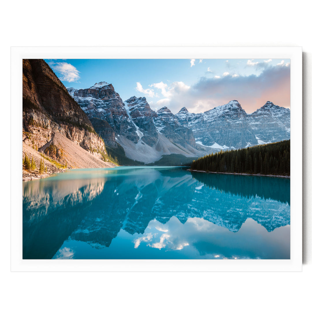 a serene mountain lake with a stunning reflection of the snow-capped peaks in the calm, turquoise waters.
